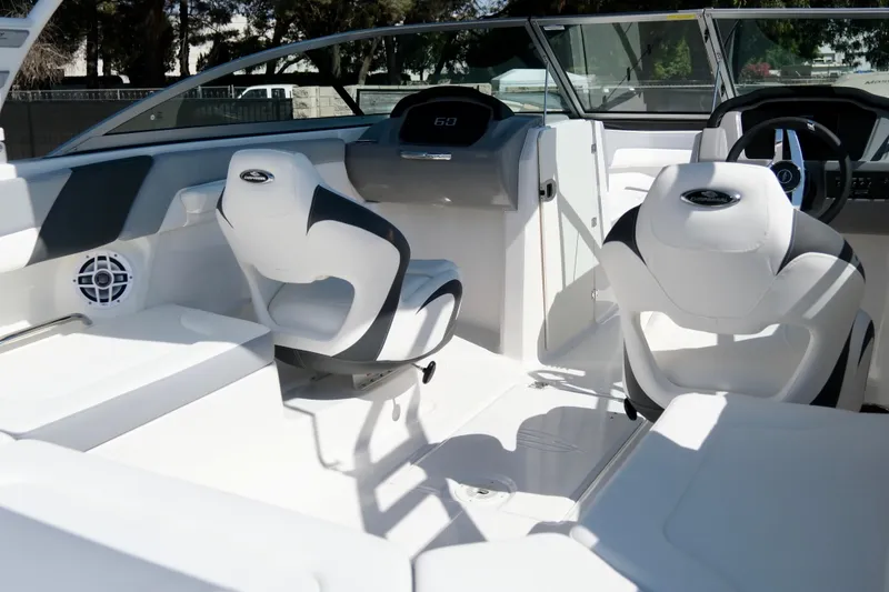 Slide: The Image of 2025 Chaparral 23 SSi boat interior with modern seating and sleek dashboard design. - 8