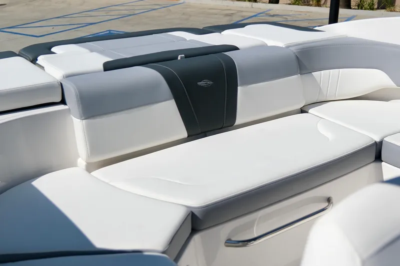 Slide: The Image of 2025 Chaparral 23 SSi boat interior with white and gray cushioned seating. - 9