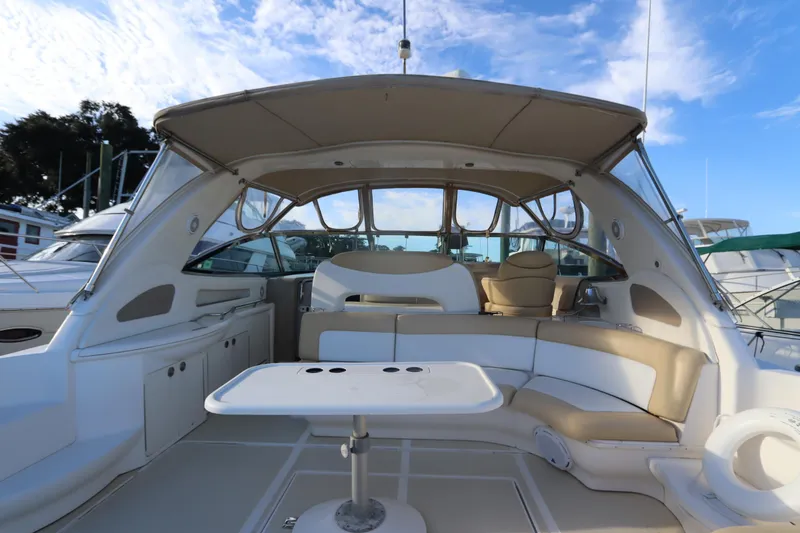 Slide: The Image of 2000 Sea Ray 460 Sundancer yacht interior with seating and table under canopy. - 11