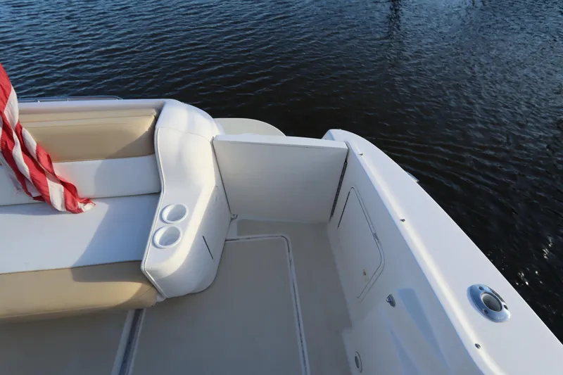 Slide: The Image of 2000 Sea Ray 460 Sundancer boat deck with seating and cup holders by the water. - 13