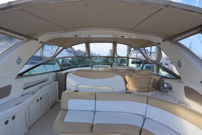 Slide: The Image of Interior view of 2000 Sea Ray 460 Sundancer yacht with beige seating and canopy. - 17