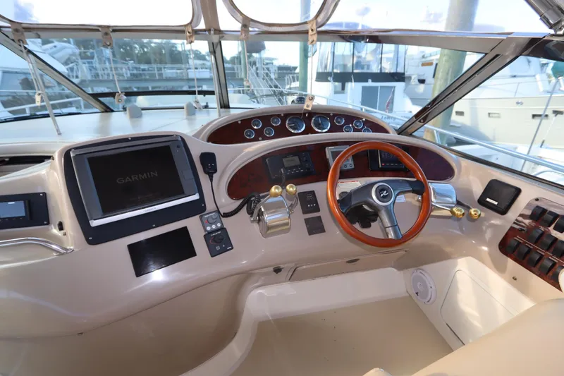 Slide: The Image of Cockpit of 2000 Sea Ray 460 Sundancer with Garmin navigation system and wooden steering wheel. - 18