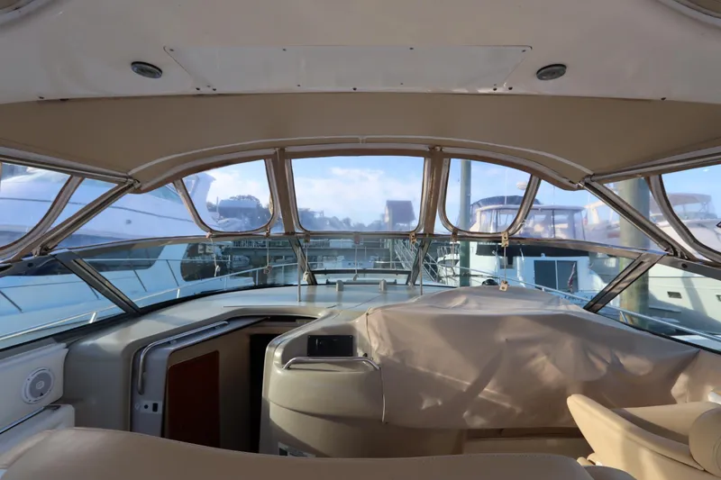Slide: The Image of Interior view of 2000 Sea Ray 460 Sundancer yacht cockpit with covered controls. - 19