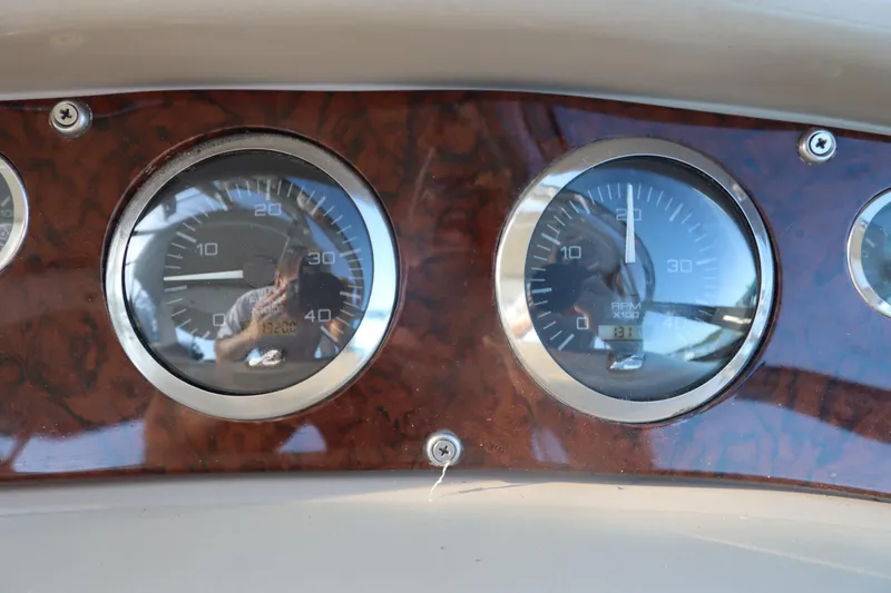 Slide: The Image of Dashboard gauges of a 2000 Sea Ray 460 Sundancer boat. - 21