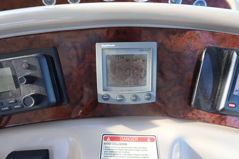 Slide: The Image of Dashboard of a 2000 Sea Ray 460 Sundancer with Raytheon marine electronics. - 29