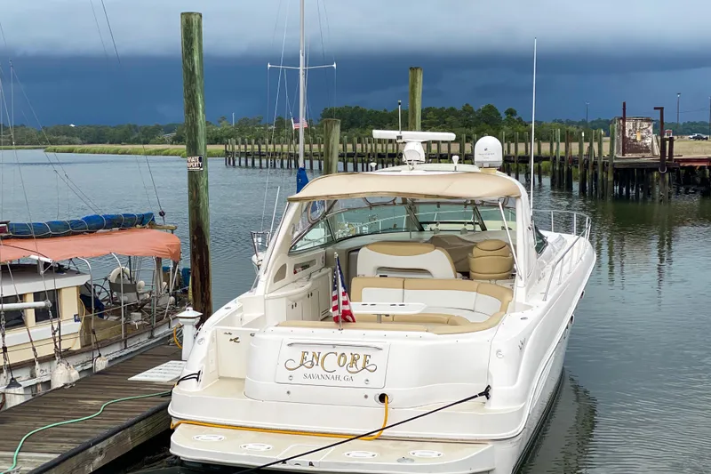 Slide: The Image of 2000 Sea Ray 460 Sundancer yacht docked at marina under cloudy sky. - 3