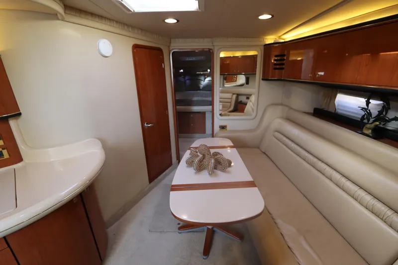 Slide: The Image of Interior of 2000 Sea Ray 460 Sundancer yacht with elegant seating and table. - 35