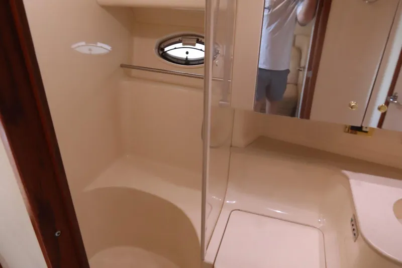 Slide: The Image of Bathroom interior of 2000 Sea Ray 460 Sundancer yacht, featuring shower and mirror. - 40