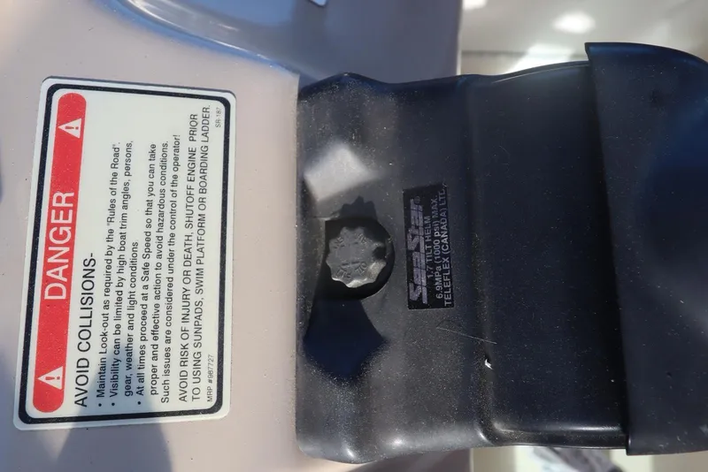 Slide: The Image of Warning label and SeaStar hydraulic steering on 2000 Sea Ray 460 Sundancer boat. - 43