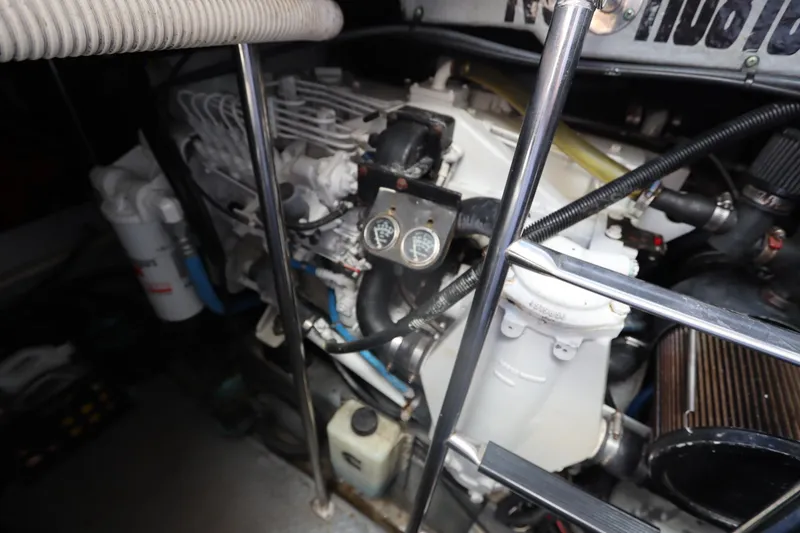 Slide: The Image of Engine compartment of a 2000 Sea Ray 460 Sundancer boat, showcasing mechanical components. - 47