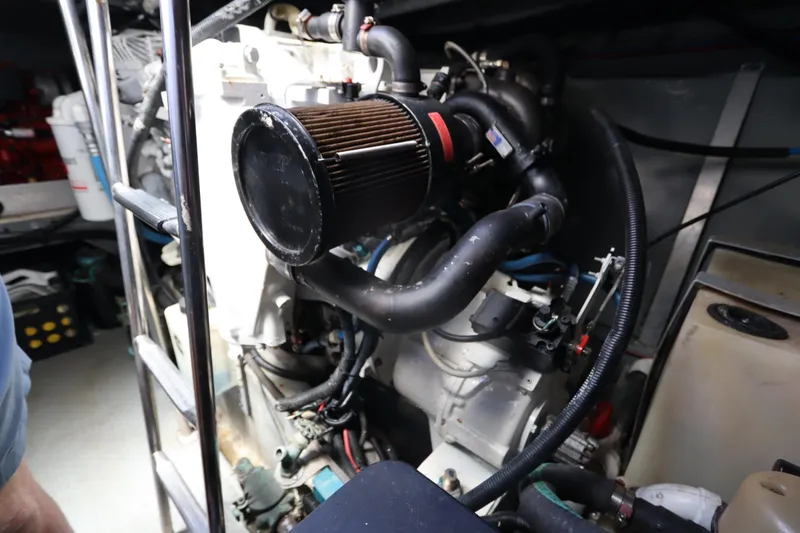 Slide: The Image of Engine room of a 2000 Sea Ray 460 Sundancer yacht, showcasing mechanical components. - 49