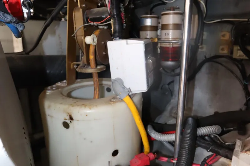 Slide: The Image of Engine compartment of a 2000 Sea Ray 460 Sundancer with visible wiring and components. - 52