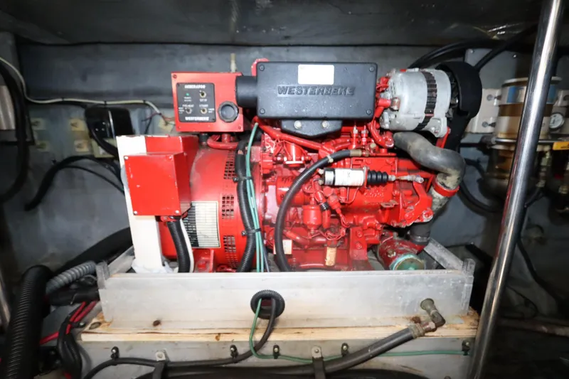 Slide: The Image of Engine compartment of a 2000 Sea Ray 460 Sundancer with a red Westerbeke generator. - 53