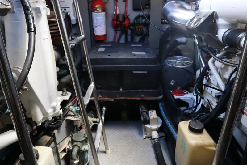 Slide: The Image of Engine room of 2000 Sea Ray 460 Sundancer with visible machinery and equipment. - 54