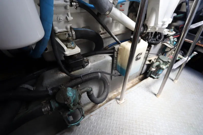 Slide: The Image of Engine room of 2000 Sea Ray 460 Sundancer with visible components and piping. - 58