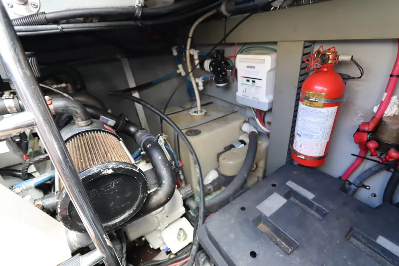 Slide: The Image of Engine room of 2000 Sea Ray 460 Sundancer with fire extinguisher and mechanical components. - 63