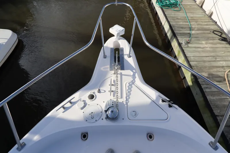 Slide: The Image of Bow view of 2000 Sea Ray 460 Sundancer docked, showing anchor and deck details. - 7