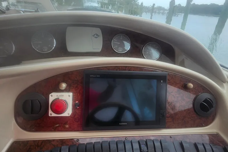 Slide: The Image of Dashboard of a 2004 Sea Ray 480 Motor Yacht with navigation and control instruments. - 10