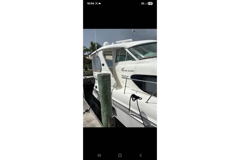 Slide: The Image of 2004 Sea Ray 480 Motor Yacht docked at marina, side view. - 4