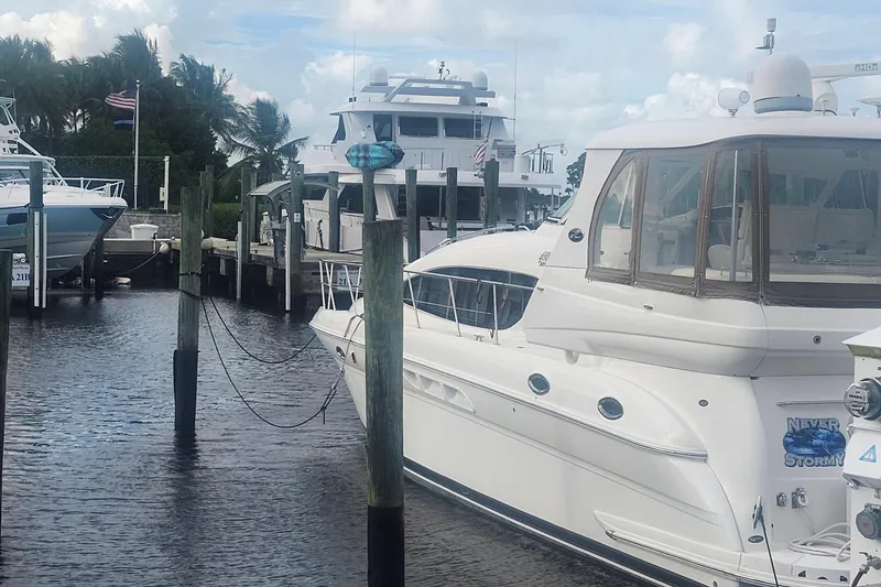 Slide: The Image of 2004 Sea Ray 480 Motor Yacht docked at marina, surrounded by other boats. - 5