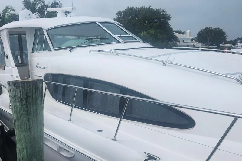 Slide: The Image of 2004 Sea Ray 480 Motor Yacht docked, showcasing sleek design and modern features. - 7