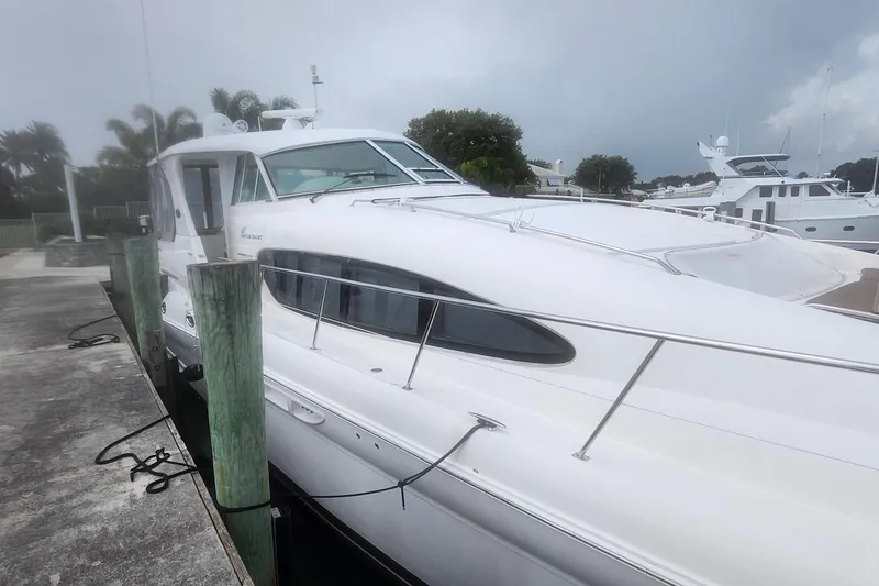 Slide: The Image of 2004 Sea Ray 480 Motor Yacht docked at marina under cloudy sky. - 8