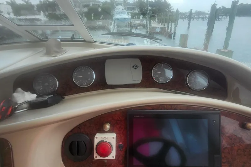 Slide: The Image of 2004 Sea Ray 480 Motor Yacht helm with gauges and navigation screen. - 9
