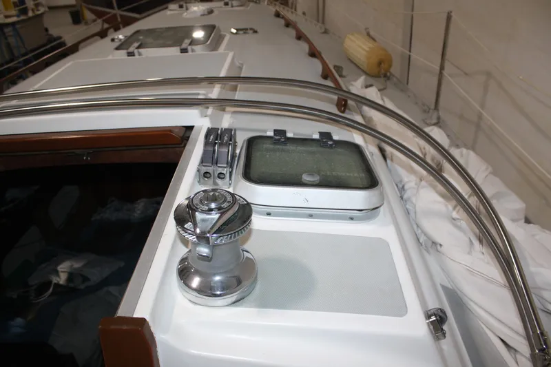 Slide: The Image of 1986 J Boats J/28 sailboat deck with winch and hatch, stored indoors. - 16