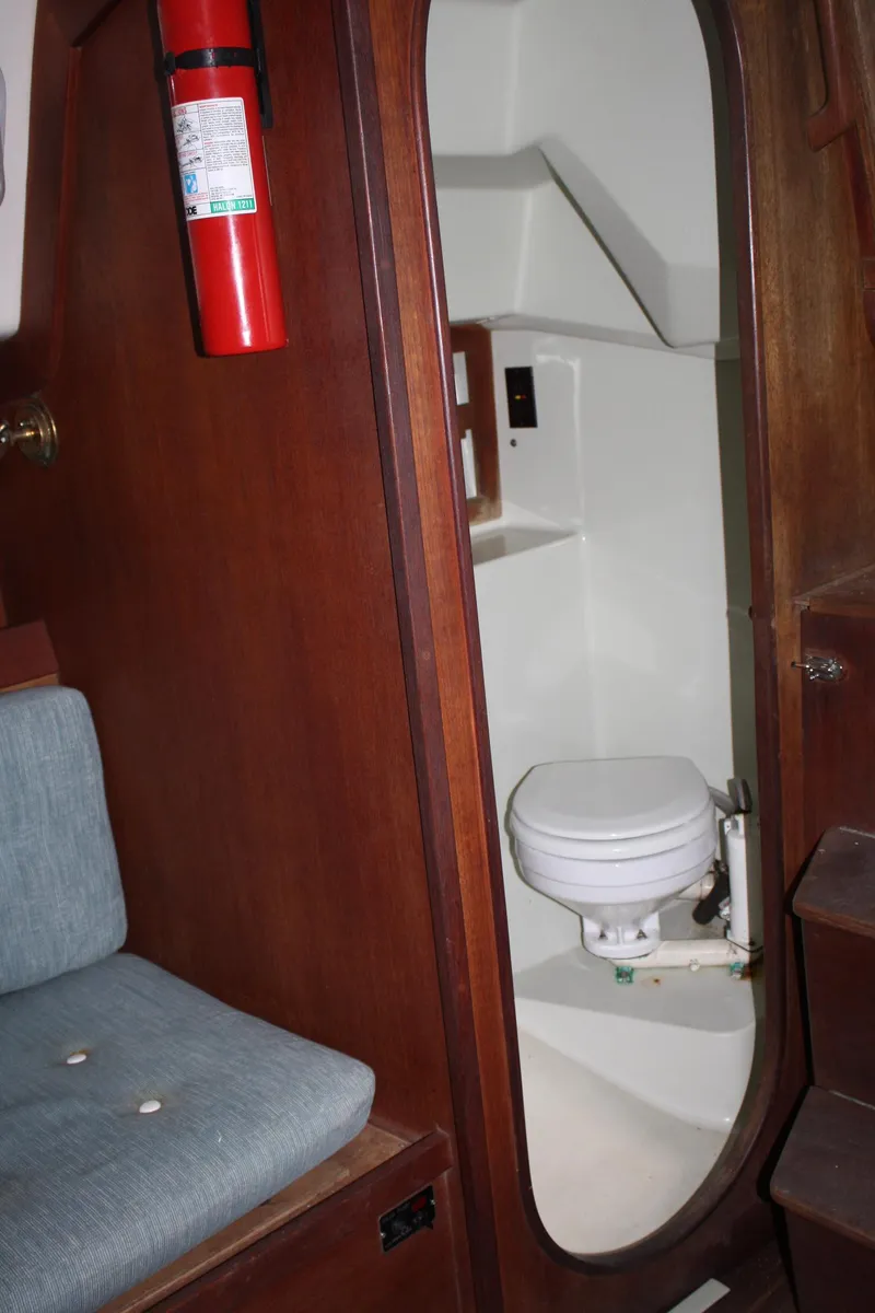 Slide: The Image of 1986 J Boats J/28 interior with compact marine toilet and wooden cabinetry. - 40
