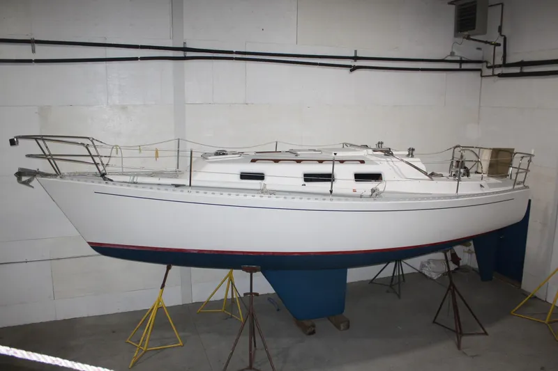 Slide: The Image of 1986 J Boats J/28 sailboat on stands in indoor storage. - 6