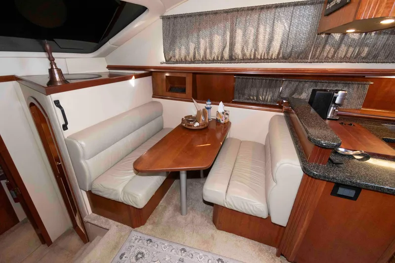 Slide: The Image of 2005 Cruisers Yachts 405 Express Motoryacht interior with dining area and kitchenette. - 13