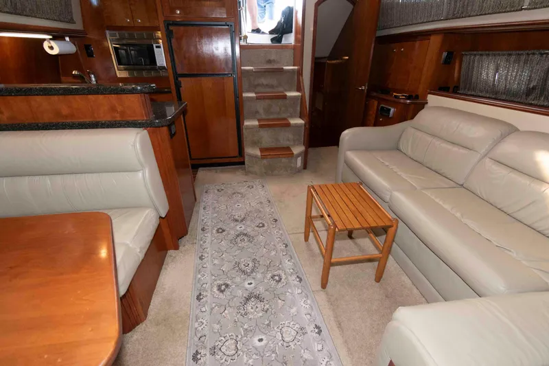 Slide: The Image of Luxurious interior of 2005 Cruisers Yachts 405 Express Motoryacht with leather seating and wooden accents. - 16