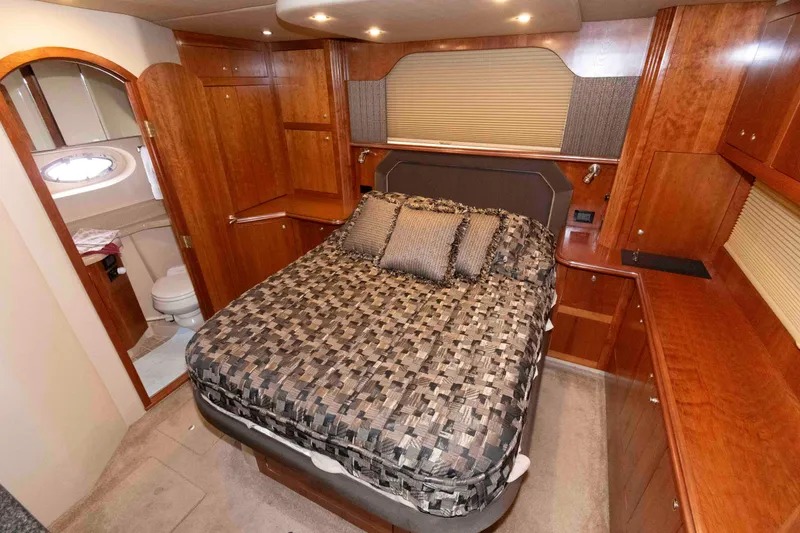 Slide: The Image of Luxurious 2005 Cruisers Yachts 405 Express Motoryacht bedroom with elegant wood cabinetry. - 17