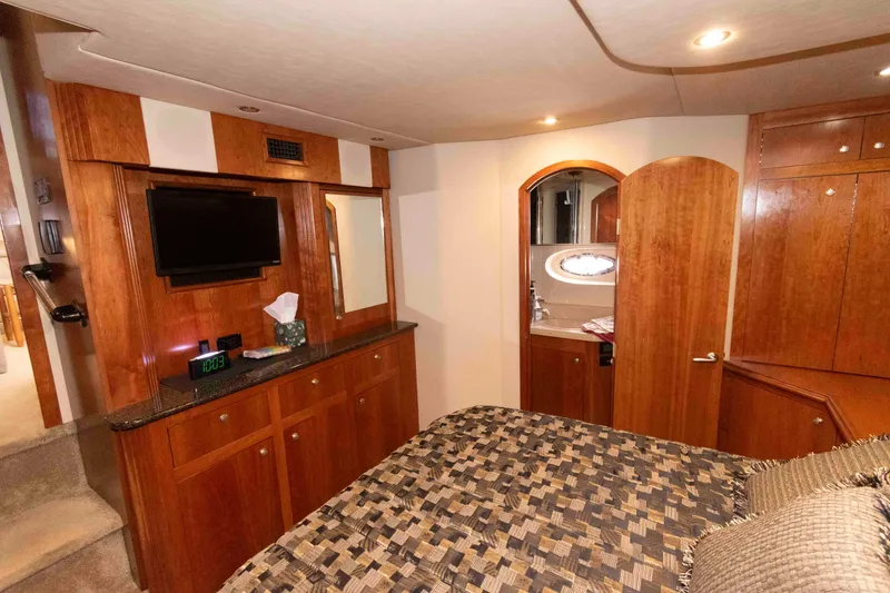 Slide: The Image of Luxurious 2005 Cruisers Yachts 405 Express Motoryacht interior with wood cabinetry and cozy bedroom. - 18