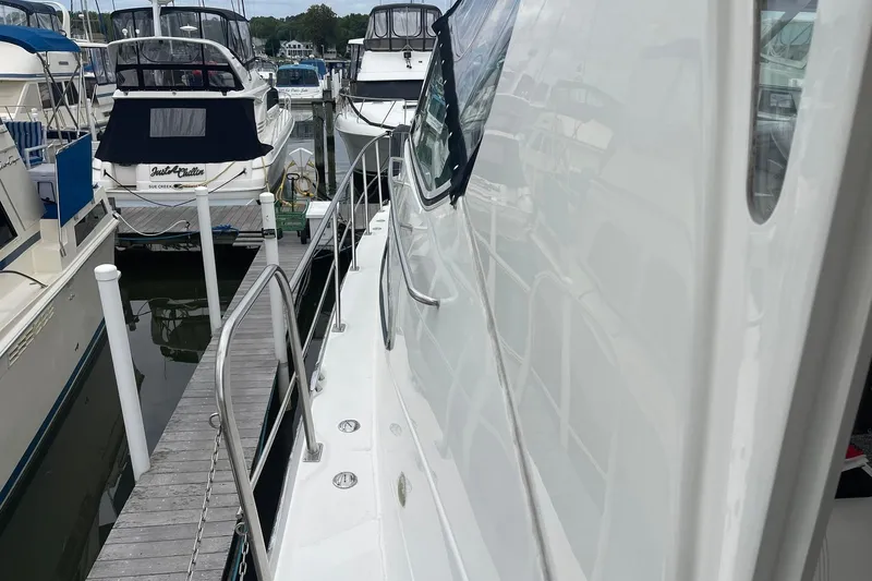 Slide: The Image of 2005 Cruisers Yachts 405 Express Motoryacht docked at marina, side view. - 3