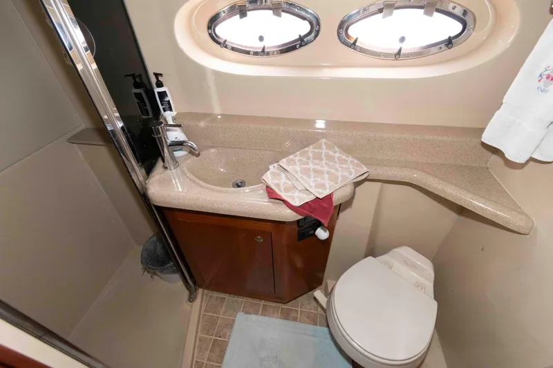 Slide: The Image of Bathroom of 2005 Cruisers Yachts 405 Express Motoryacht with sink, toilet, and porthole windows. - 19