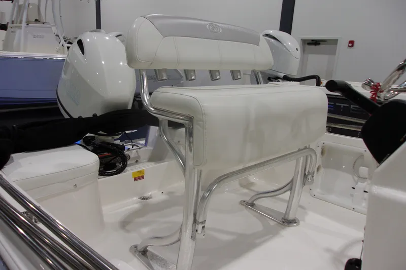 Slide: The Image of 2022 Key West 1720 Sportsman boat interior with white seating and motor. - 11