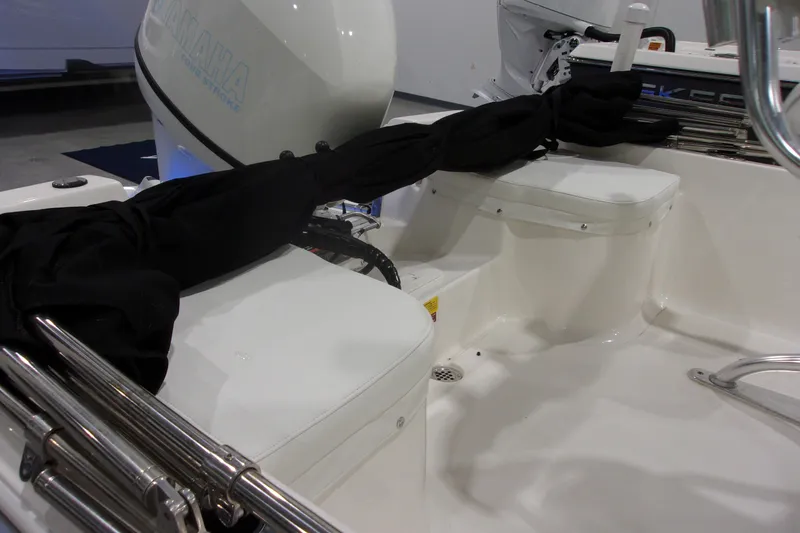 Slide: The Image of 2022 Key West 1720 Sportsman boat interior with Yamaha engine, featuring white seating and black covers. - 12
