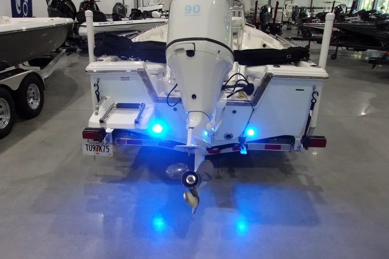 Slide: The Image of 2022 Key West 1720 Sportsman boat with illuminated blue lights in a showroom. - 13