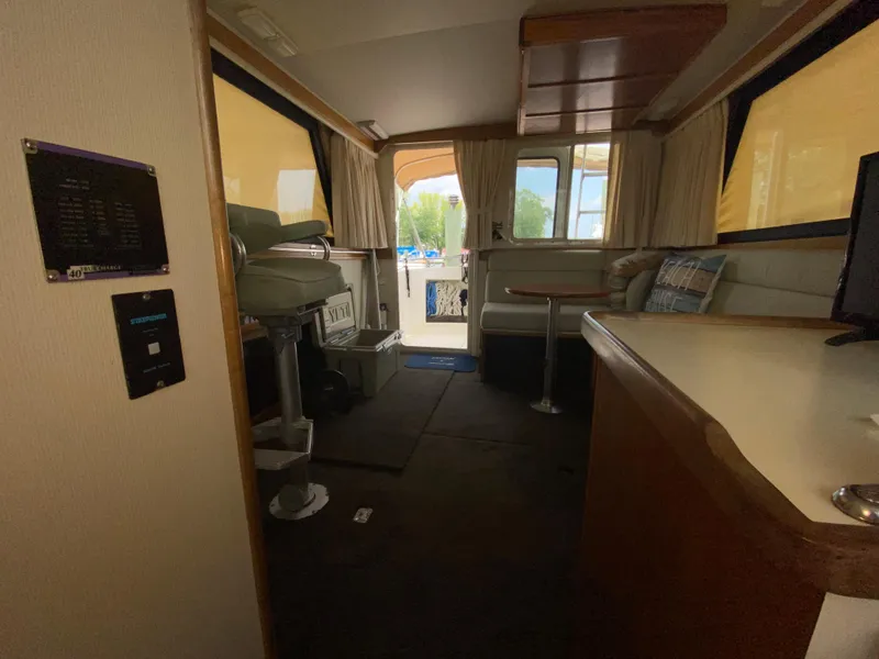 Slide: The Image of Interior of a 1998 Camano Troll 31 boat, featuring seating and helm area. - 18