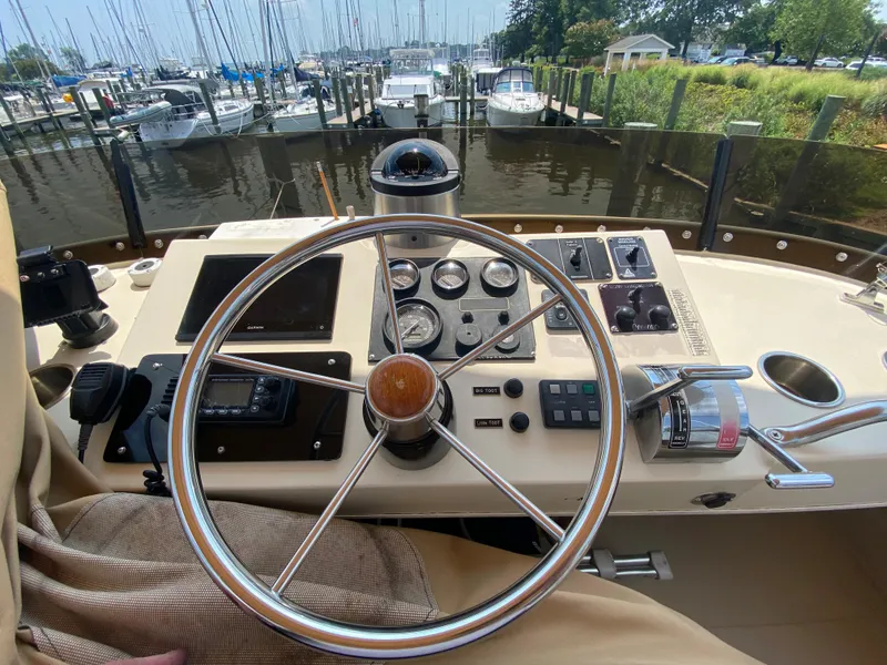 Slide: The Image of Helm of 1998 Camano Troll 31 boat with steering wheel and control panel. - 2