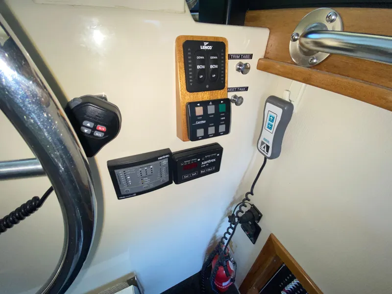 Slide: The Image of Control panel of a 1998 Camano Troll 31 boat with various switches and devices. - 20