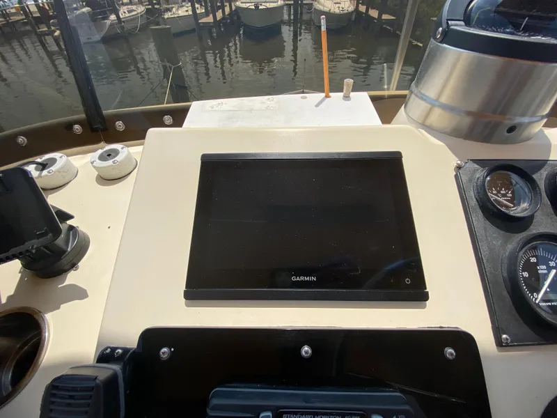 Slide: The Image of 1998 Camano Troll 31 helm with Garmin display and navigation instruments. - 22