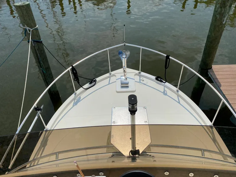 Slide: The Image of Bow view of 1998 Camano Troll 31 boat docked at marina. - 23