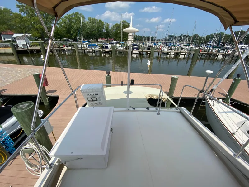 Slide: The Image of 1998 Camano Troll 31 docked at a marina, featuring a spacious deck and scenic waterfront view. - 24