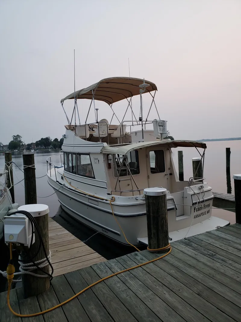 Slide: The Image of 1998 Camano Troll 31 boat docked at a marina during sunset. - 28