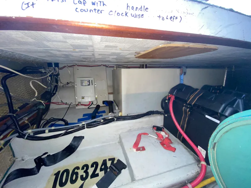 Slide: The Image of 1998 Camano Troll 31 engine compartment with wiring, battery, and equipment. - 37