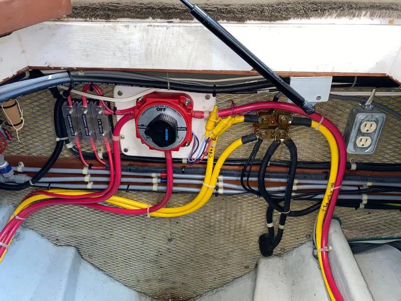 Slide: The Image of Electrical wiring setup in a 1998 Camano Troll 31 boat, featuring switches and outlets. - 38