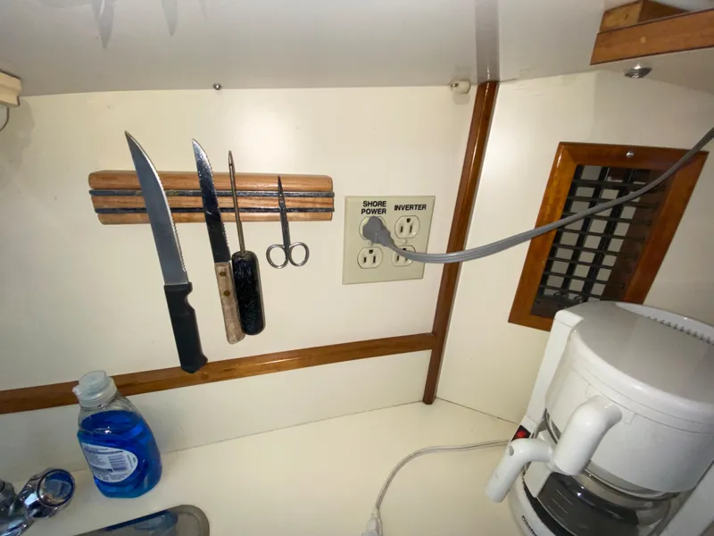 Slide: The Image of Kitchen area of a 1998 Camano Troll 31 boat with knives and coffee maker. - 41