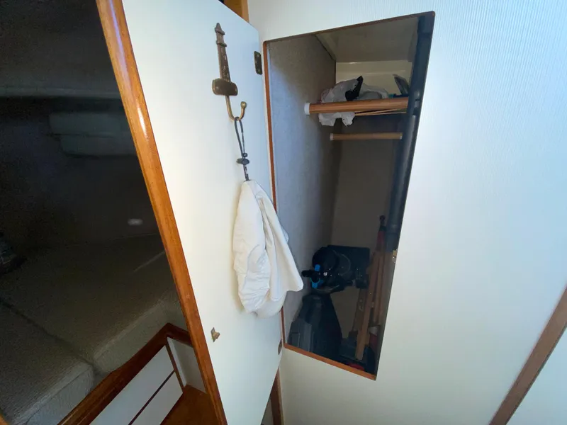 Slide: The Image of Interior of 1998 Camano Troll 31 boat showing a closet and storage area. - 42